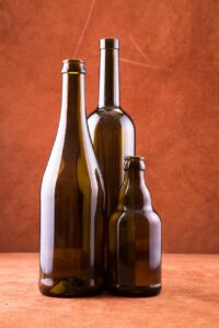 Premium glass bottles with wet-glue labels showcasing traditional cold-glue application technology