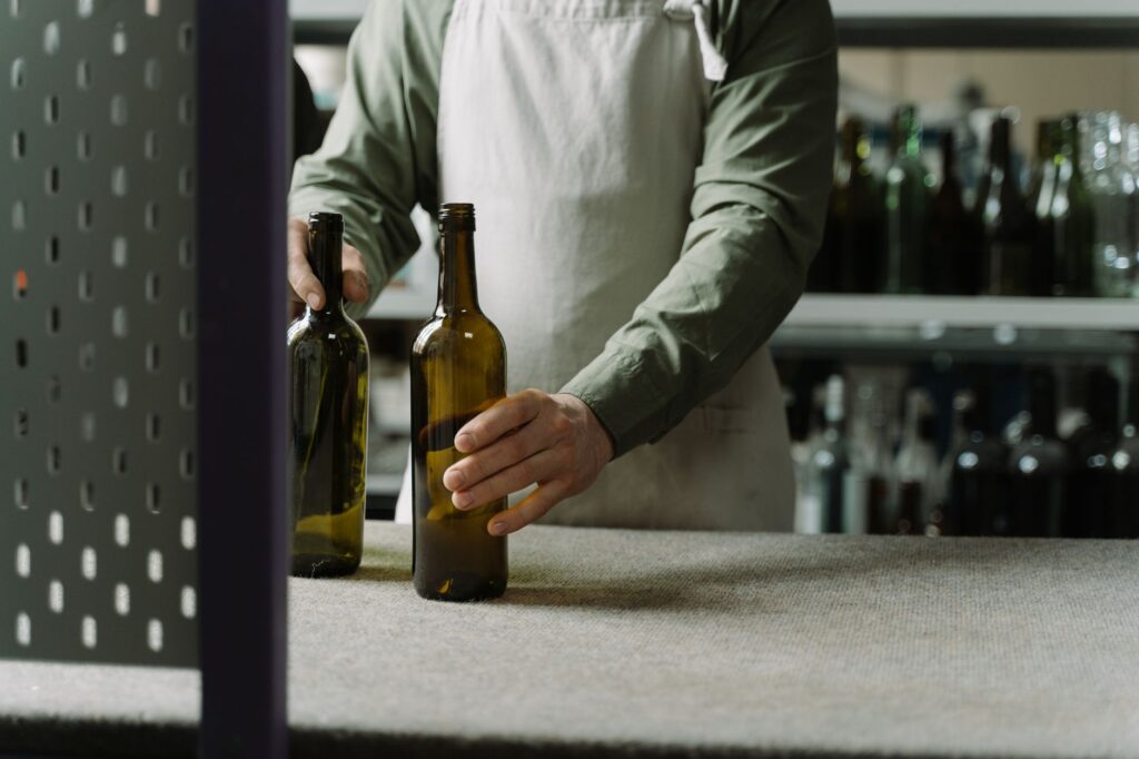 Empty custom glass bottles arranged on a counter ready for a low MOQ order