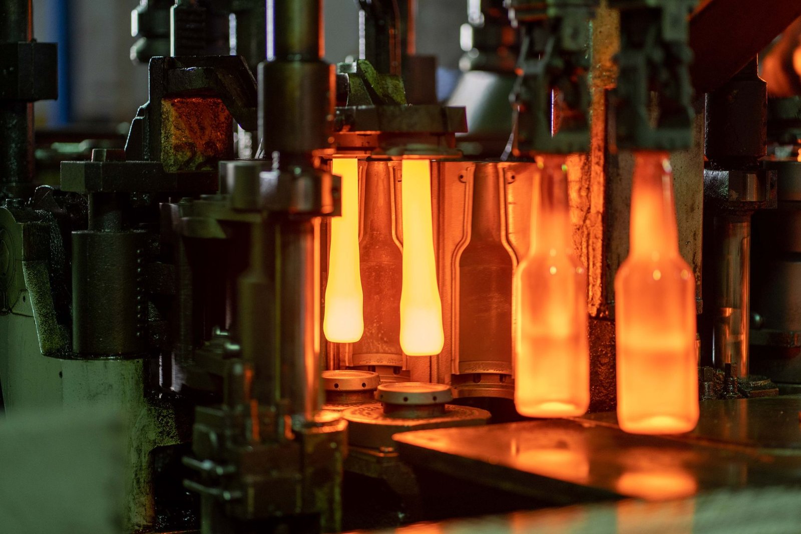 Glass bottles being shaped on a factory production line