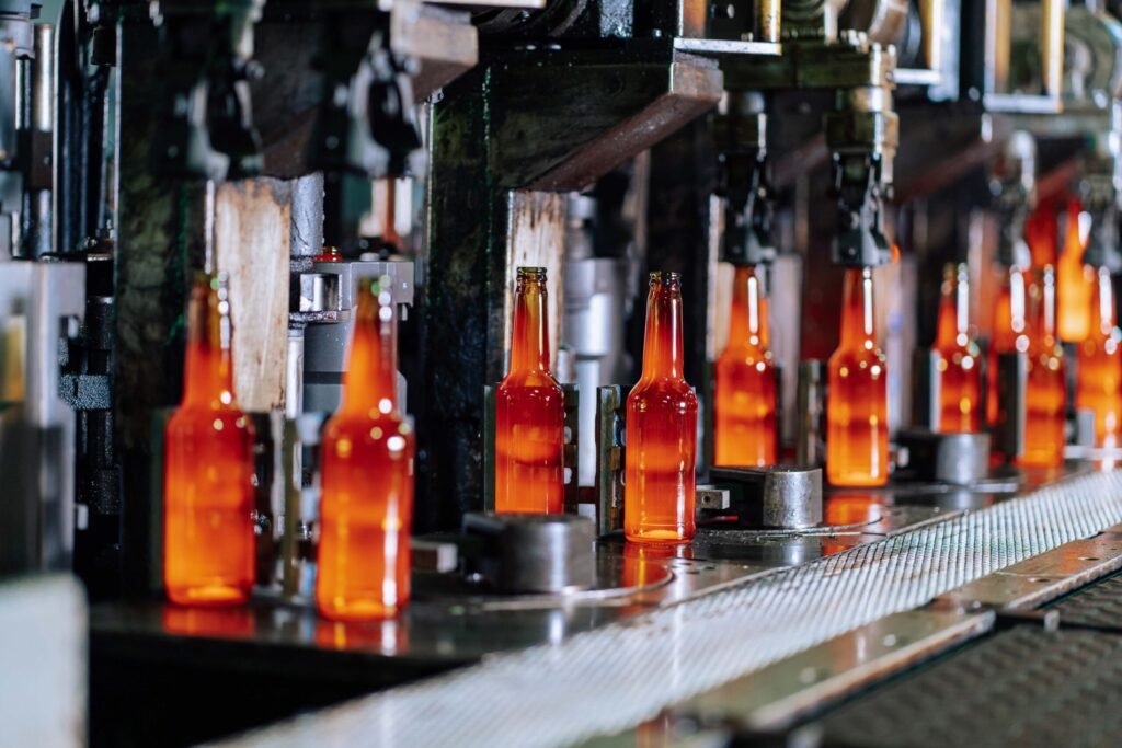 Glass bottles moving along a production line in a glass bottle factory