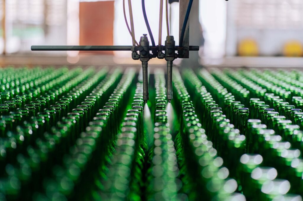 Glass bottles moving through an automated production line at a glass bottle manufacturer
