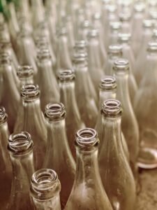 Glass bottles being shaped on a factory production line