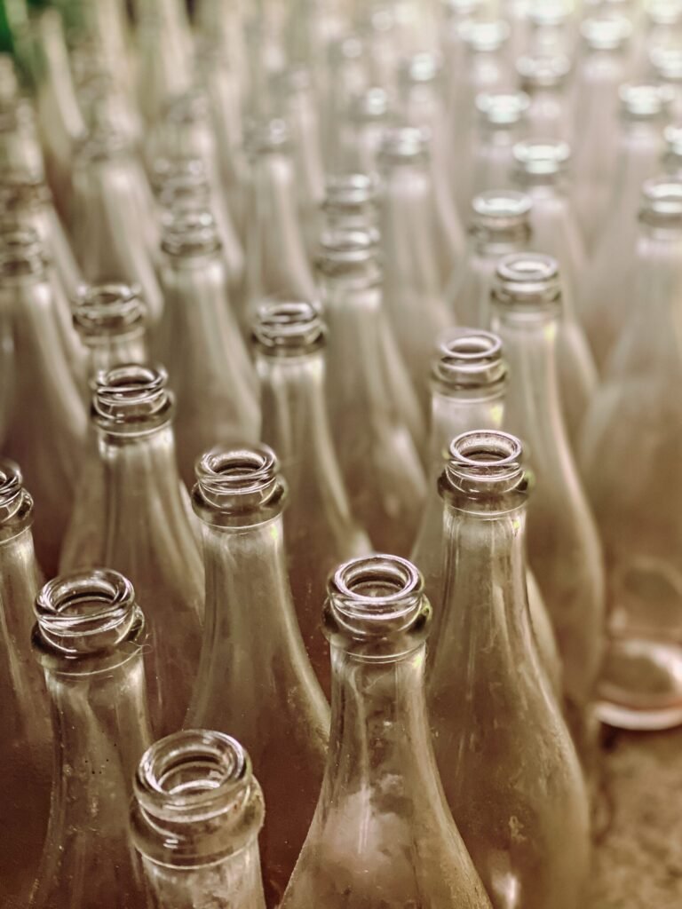 Glass bottles being shaped on a factory production line