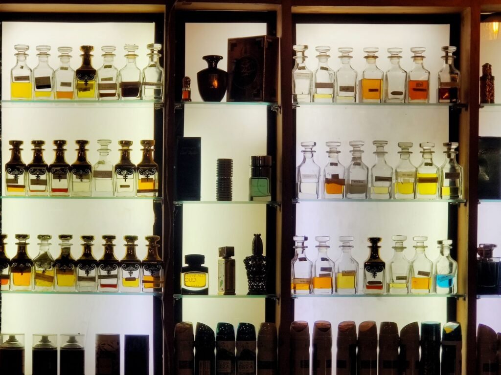 Rows of glass perfume bottles displayed in a luxury fragrance retail setting
