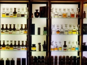 Rows of glass perfume bottles displayed in a luxury fragrance retail setting