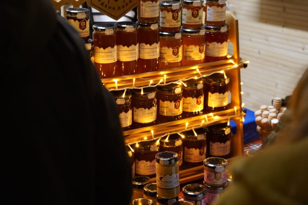 Glass honey jars displayed on a market shelf